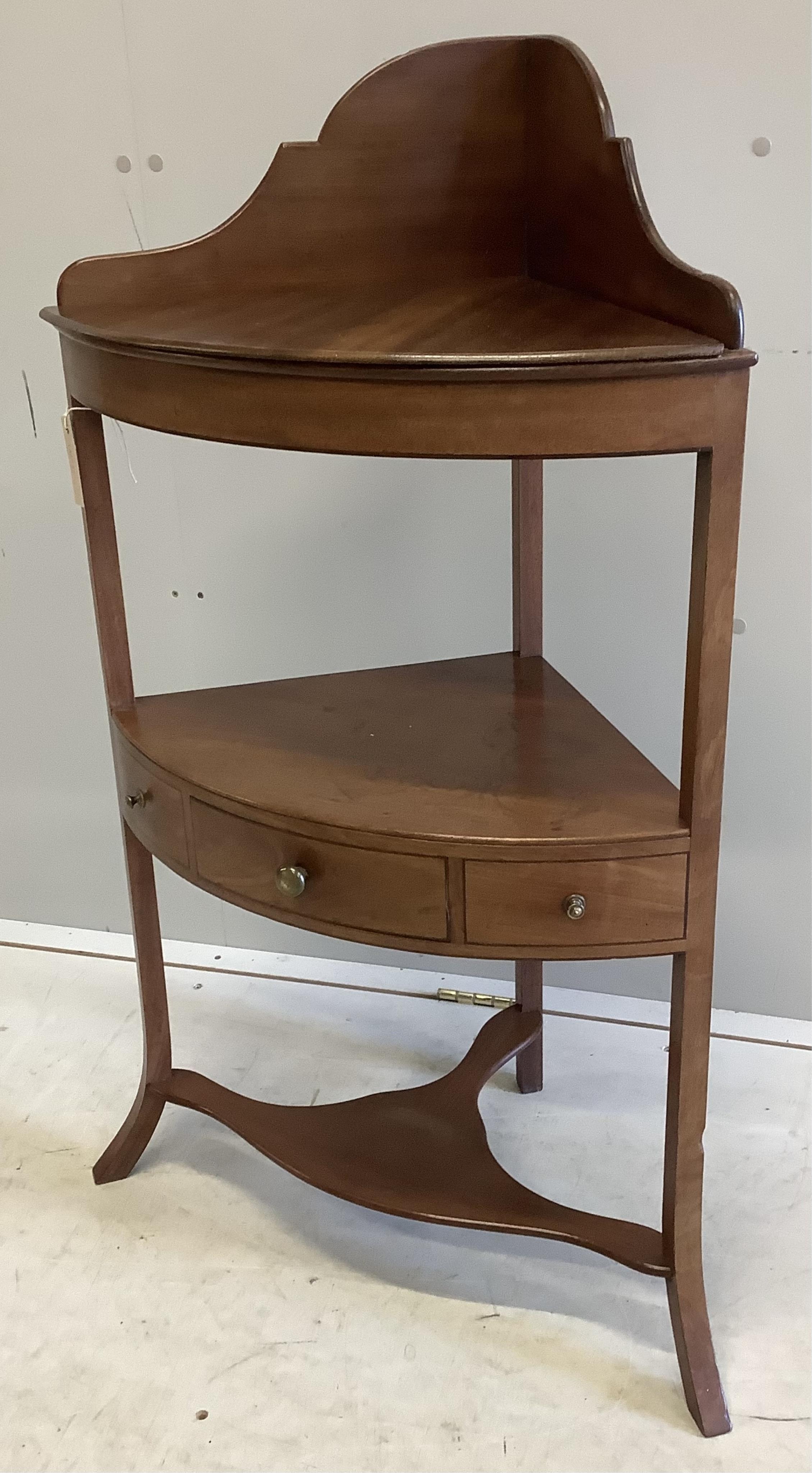 A George III mahogany two tier bow front corner washstand, width 57cm, depth 37cm, height 99cm. Condition - fair